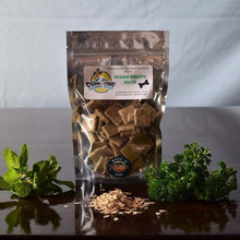 Load image into Gallery viewer, Doggie Style Gourmet Treats Doggie Breath Mints in a pouch with mint and parsley on a wooden surface.