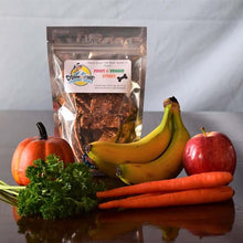 Load image into Gallery viewer, Doggie Style Gourmet Treats pack with carrots, apples, bananas, pumpkin, and parsley on a wooden table.