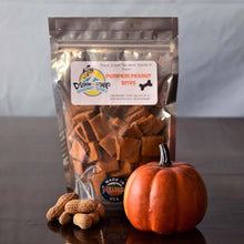 Load image into Gallery viewer, Packaged Pumpkin Peanut Bites dog treats with peanuts and a decorative pumpkin on wooden table.