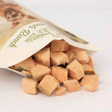 Load image into Gallery viewer, Badlands Ranch freeze-dried salmon bites for dogs, showcasing bite-sized treats spilling from the bag.