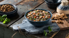 Load image into Gallery viewer, Bowl of Fromm Frommbalaya Pork stew with vegetables and rice on rustic wooden table.