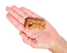 Load image into Gallery viewer, Real Strips Turkey w/ Pumpkin treat held in a hand, showcasing its soft texture and portion size.