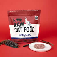 RAWR Cat Sliders Turkey 2.5lb bag with turkey food on a plate and feathers, highlighting quality cat food ingredients.