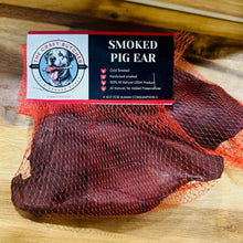 Load image into Gallery viewer, The Craft Butcher Smoked Pig Ears for Dogs in netting, 100% natural and cold-smoked for rich flavor.