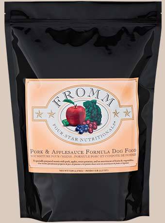 Fromm Four-Star Pork & Applesauce dog food bag featuring pork, apples, and vegetables in a black packaging.